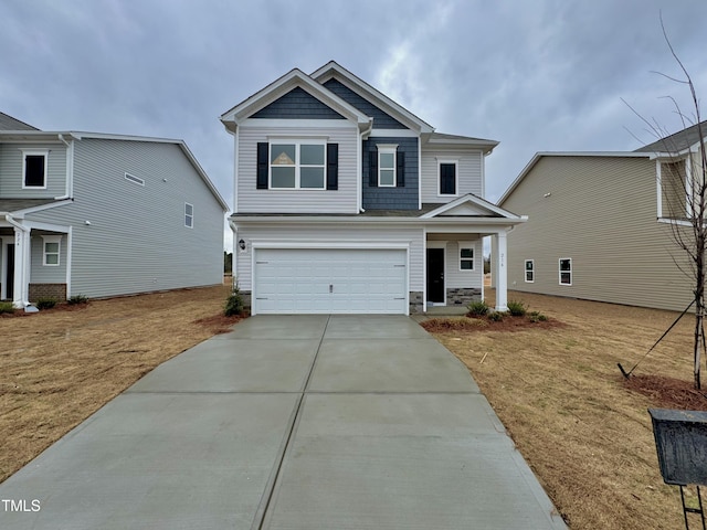 craftsman inspired home with driveway, stone siding, and an attached garage