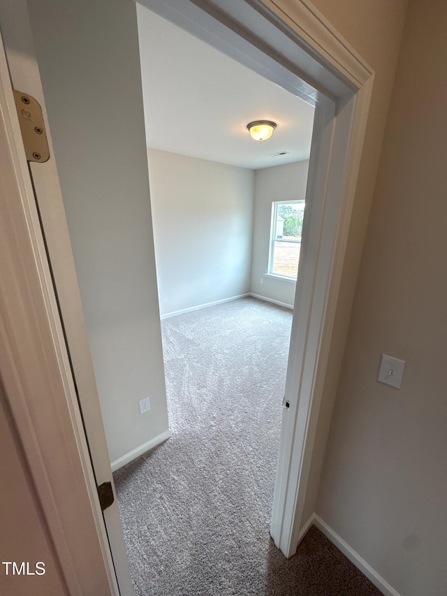 empty room with carpet flooring and baseboards