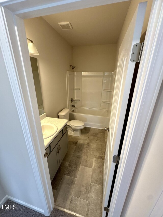 full bathroom featuring toilet,  shower combination, vanity, and visible vents