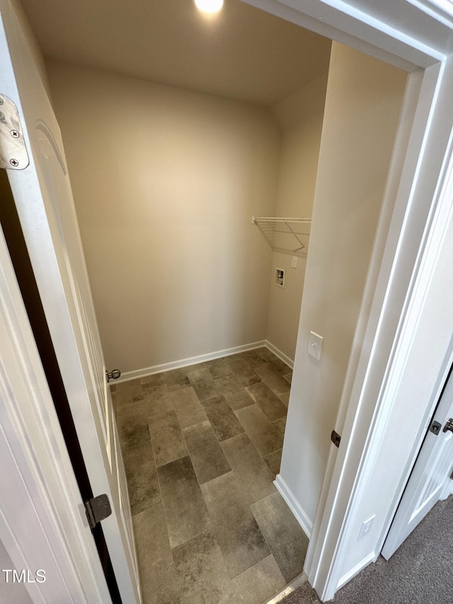 laundry room featuring washer hookup and baseboards