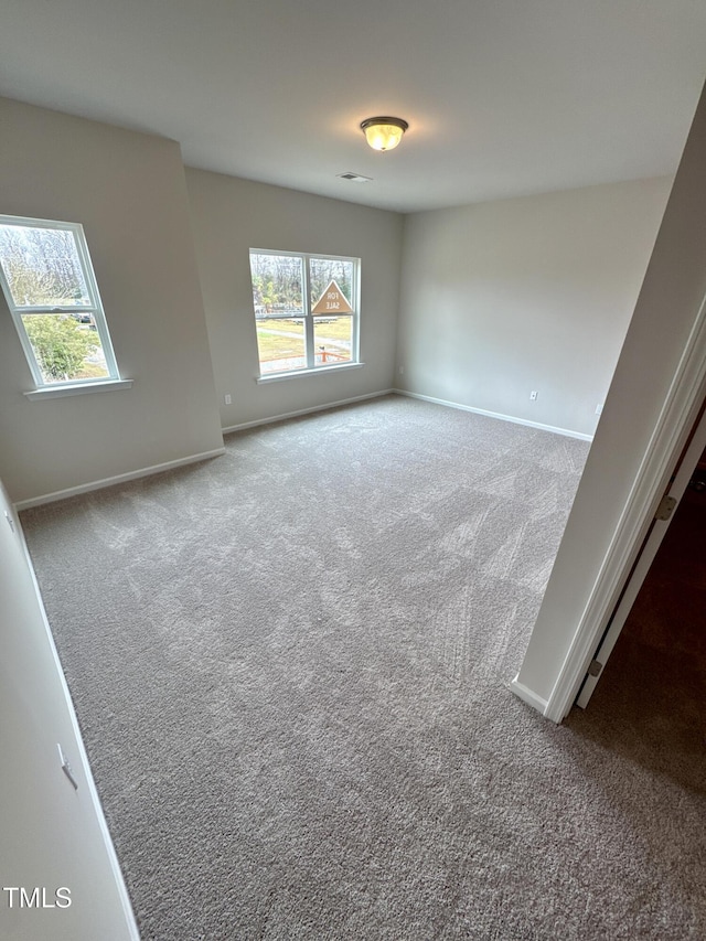 empty room with carpet flooring and baseboards