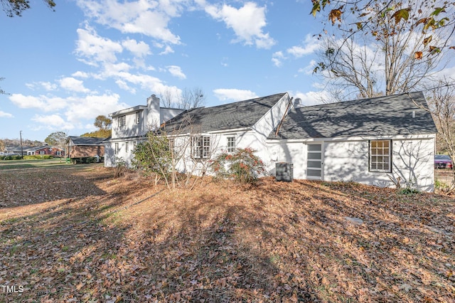 rear view of house featuring central AC unit