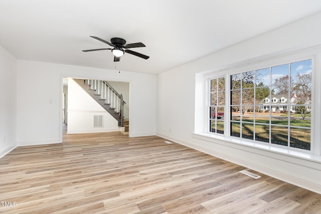 unfurnished living room with ceiling fan and light hardwood / wood-style floors