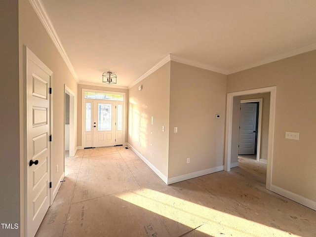 foyer entrance with ornamental molding and baseboards