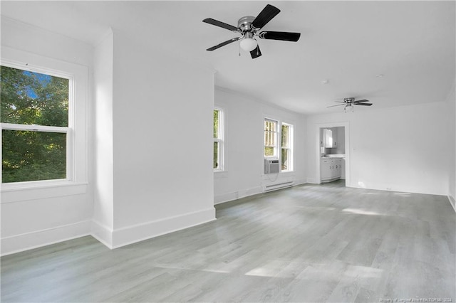 empty room with baseboard heating, cooling unit, light hardwood / wood-style floors, and ceiling fan