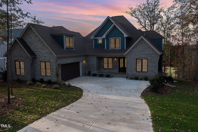 view of front of house with a garage and a lawn