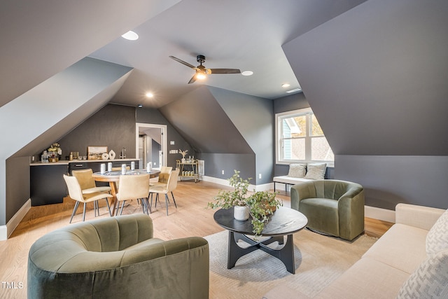 living room featuring lofted ceiling, light wood-type flooring, and ceiling fan