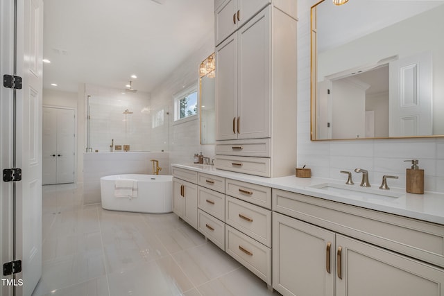 bathroom featuring tasteful backsplash, separate shower and tub, tile patterned floors, tile walls, and vanity