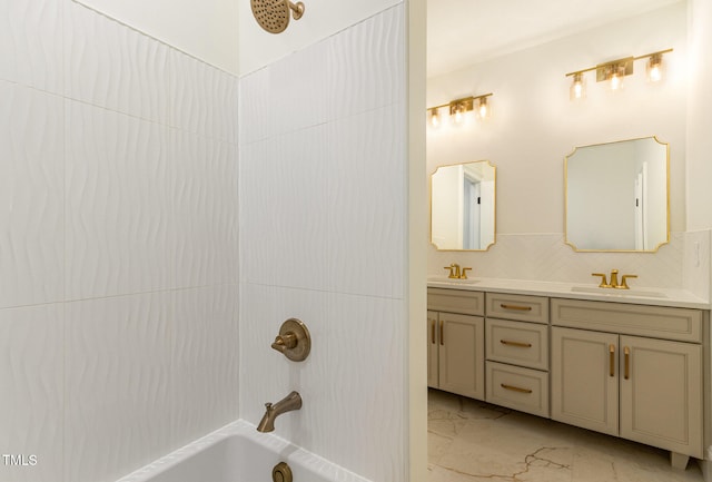 bathroom with vanity, shower / bathing tub combination, and backsplash