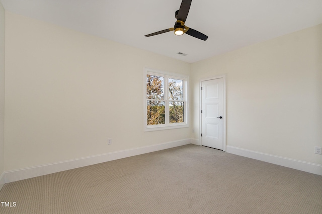 empty room with light colored carpet and ceiling fan