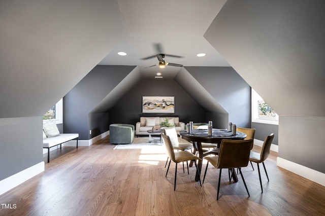 dining area with ceiling fan, lofted ceiling, a wealth of natural light, and hardwood / wood-style floors