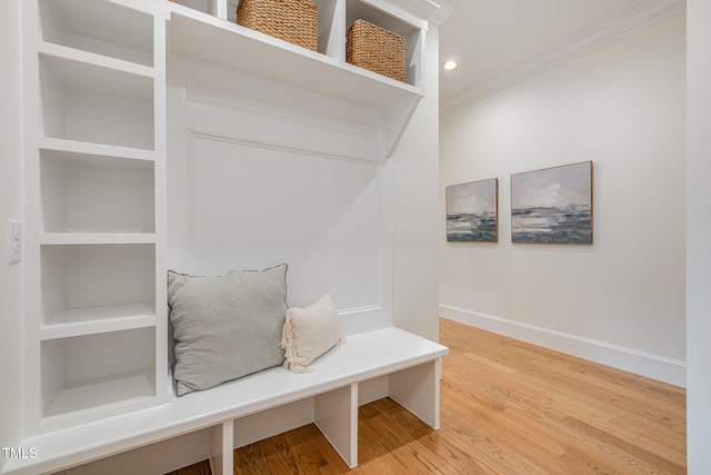 mudroom featuring ornamental molding and hardwood / wood-style flooring