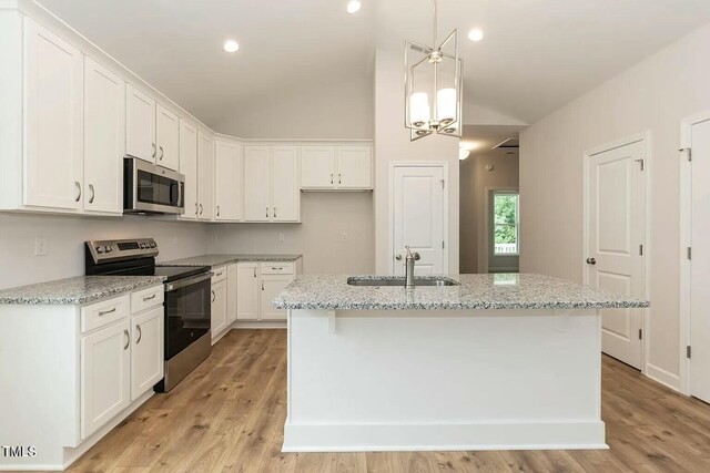 kitchen featuring white cabinetry, sink, an island with sink, and appliances with stainless steel finishes