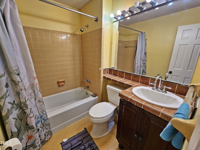 full bathroom with tile patterned floors, vanity, shower / bath combo with shower curtain, and toilet