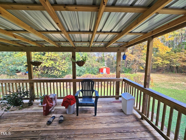 wooden terrace with a lawn