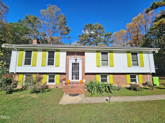 split foyer home with a front lawn