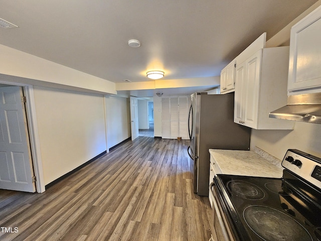 kitchen featuring electric range oven, stainless steel fridge, white cabinetry, and hardwood / wood-style flooring