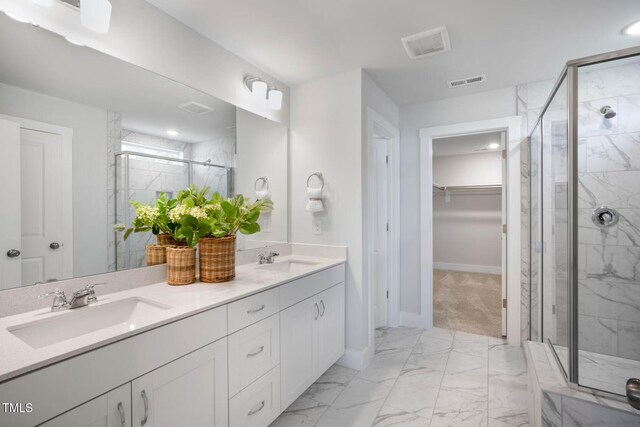 bathroom with vanity and a shower with door