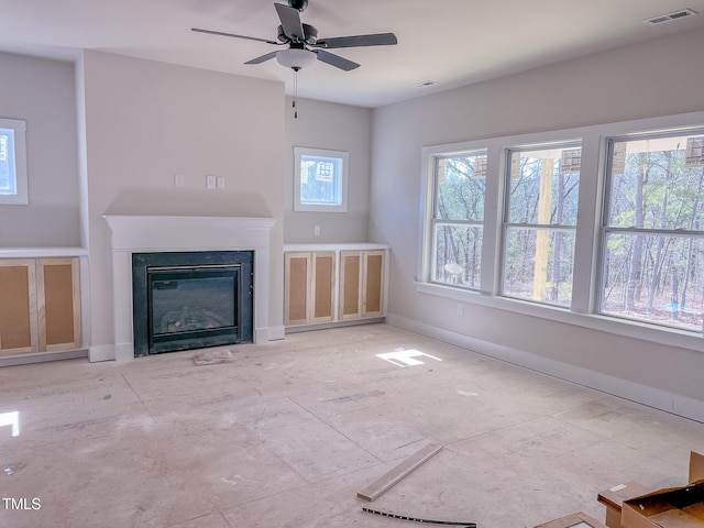 unfurnished living room with ceiling fan