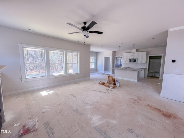 unfurnished living room with ceiling fan