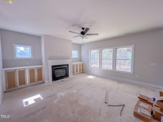 unfurnished living room with ceiling fan