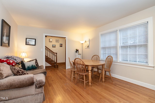 dining space with light hardwood / wood-style flooring