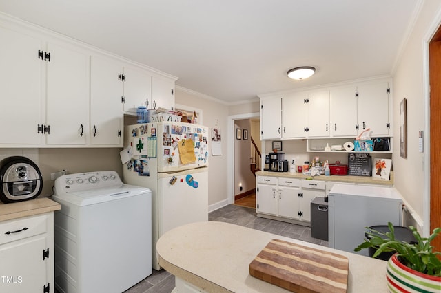 laundry area with light hardwood / wood-style floors and ornamental molding