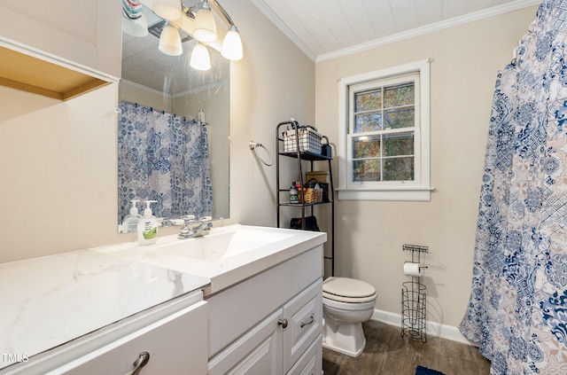 bathroom with a shower with shower curtain, ornamental molding, vanity, hardwood / wood-style flooring, and toilet