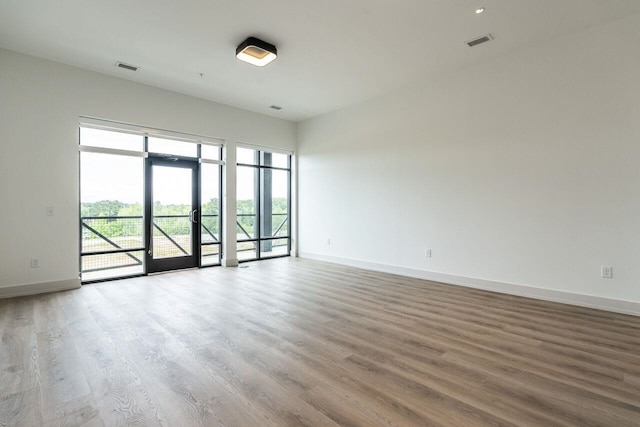 unfurnished room with wood-type flooring