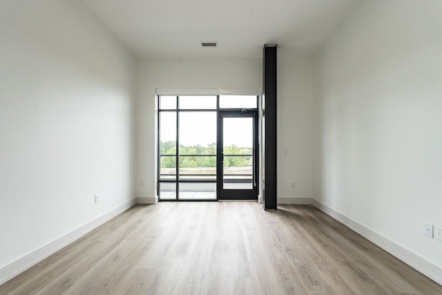 spare room featuring light wood-type flooring