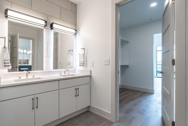 bathroom with wood-type flooring, vanity, and plenty of natural light