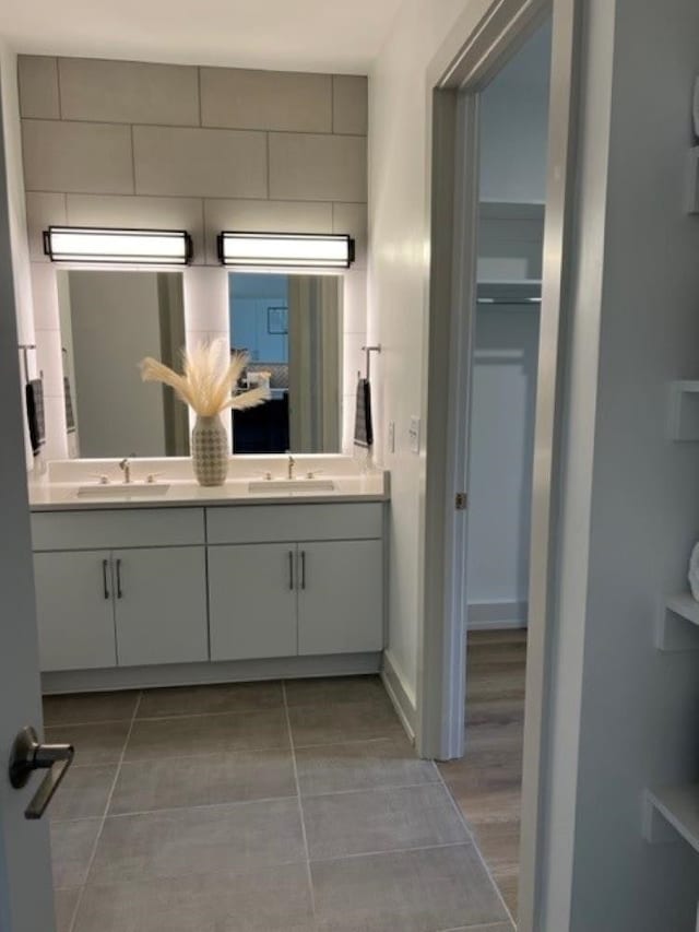 bathroom featuring vanity, wood-type flooring, and backsplash