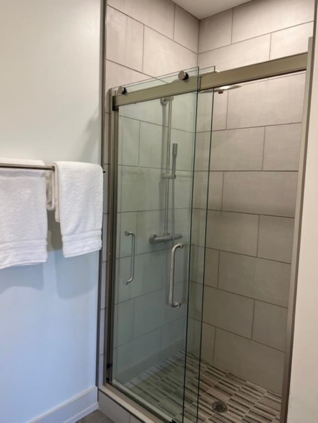 bathroom with a shower with shower door