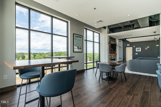 dining space with a fireplace and hardwood / wood-style floors