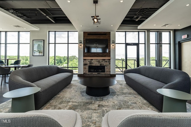 living room with a fireplace and plenty of natural light