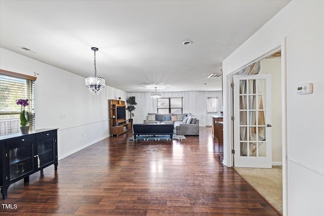 interior space with a notable chandelier and dark hardwood / wood-style floors