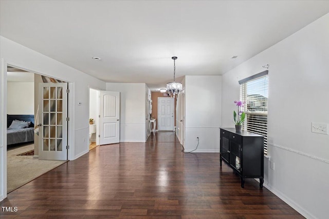 dining area with a chandelier and dark hardwood / wood-style flooring