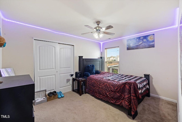 carpeted bedroom with a closet and ceiling fan