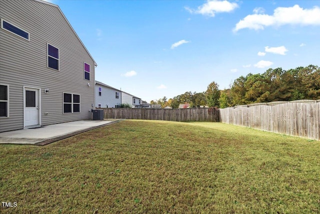 view of yard with central AC and a patio