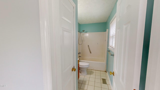 bathroom featuring shower / tub combination, tile patterned floors, toilet, and a textured ceiling