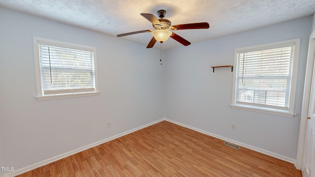 unfurnished room featuring ceiling fan, a textured ceiling, and light hardwood / wood-style floors