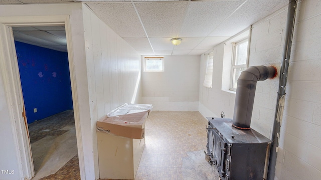 basement with a drop ceiling and plenty of natural light