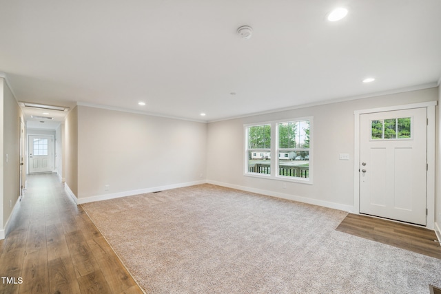 unfurnished living room with wood-type flooring and crown molding