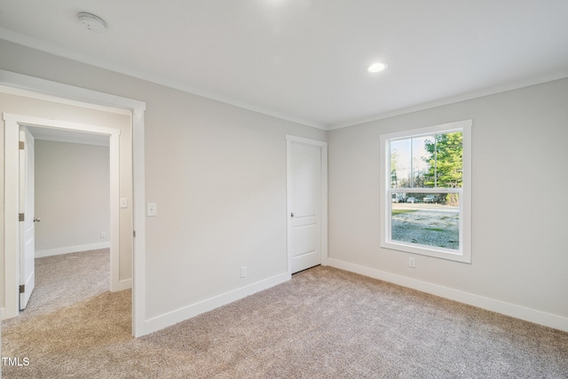 carpeted empty room with ornamental molding