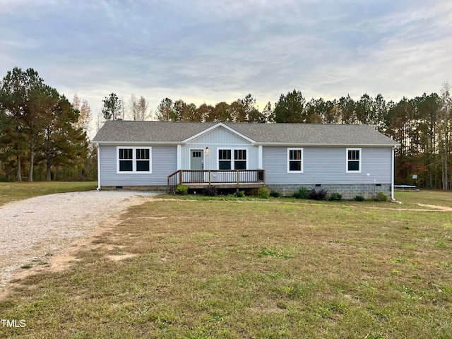 manufactured / mobile home featuring a front lawn and a wooden deck