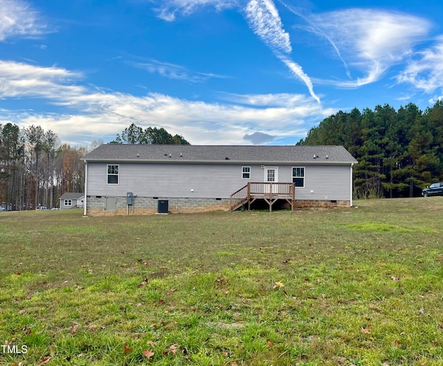 back of property with a yard and a deck