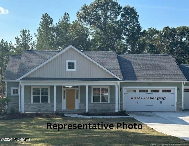 view of front facade with covered porch, a garage, and a front lawn