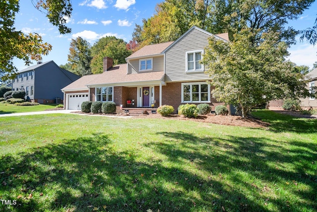 view of front property featuring a garage, a front yard, and a porch