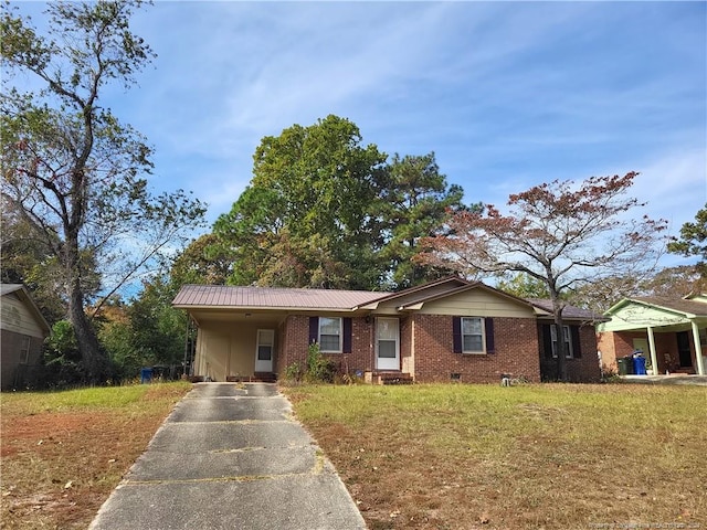 ranch-style home featuring a front yard and a carport