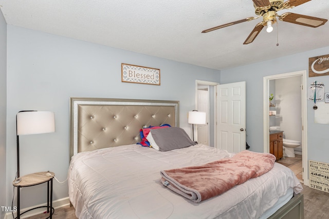 bedroom featuring hardwood / wood-style flooring, a textured ceiling, ceiling fan, and connected bathroom